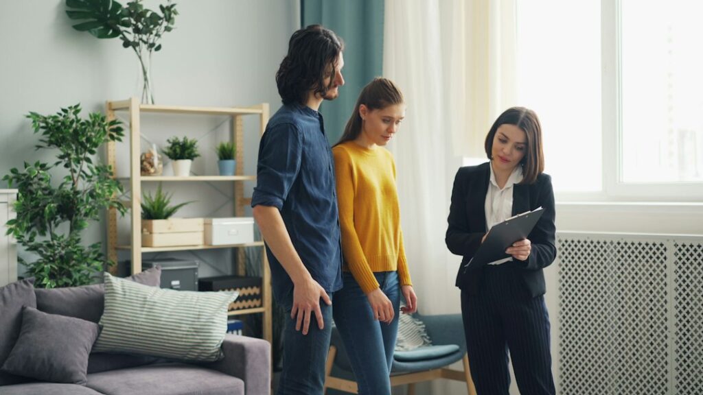 Homeowner and professional discussing home care inside a living room