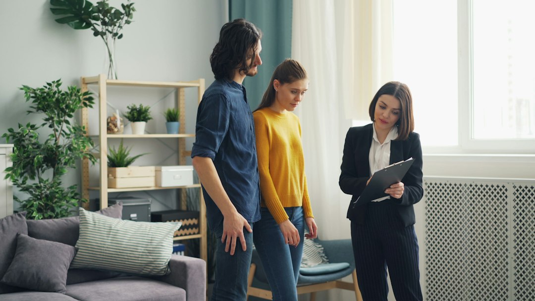 Homeowner and professional discussing home care inside a living room