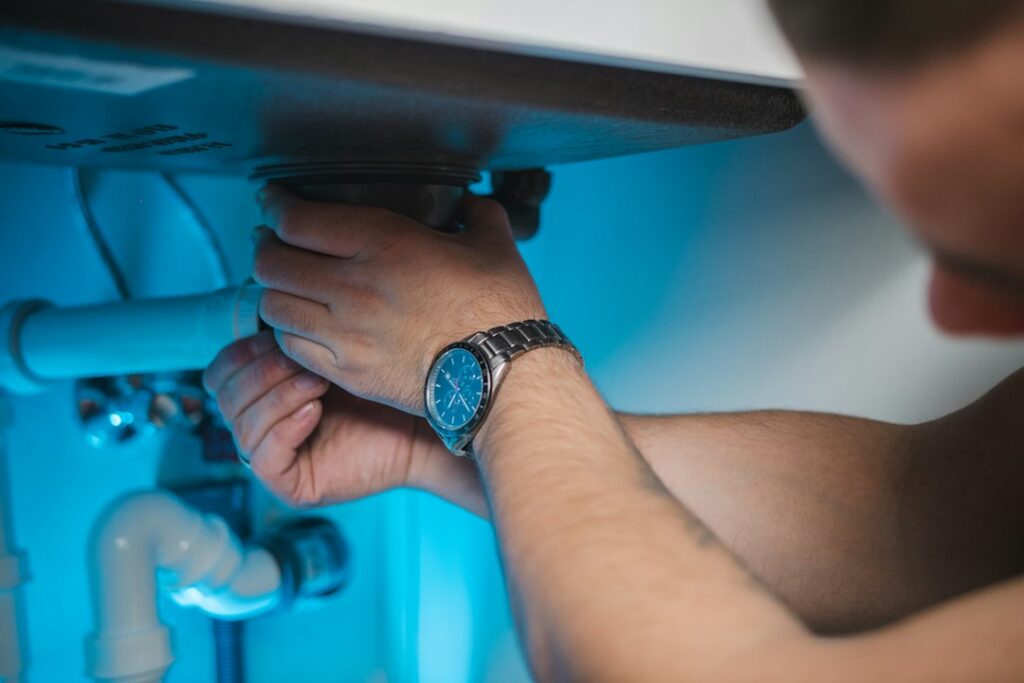 Home maintenance technician servicing a residential water heater